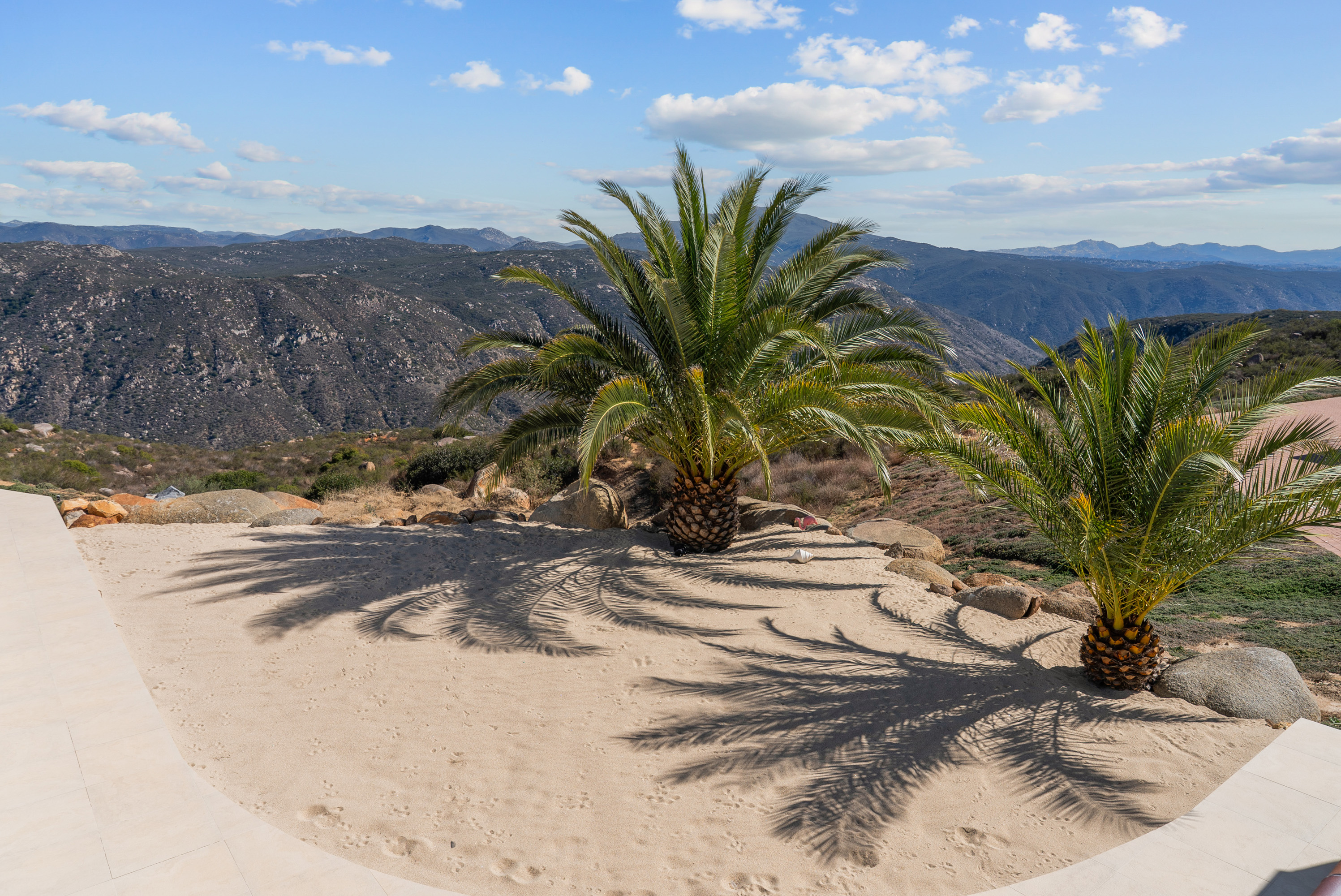 Palm shadows and panoramic mountain views from the estate
